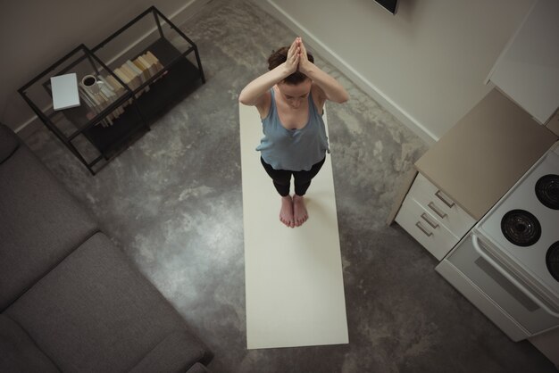 Woman performing yoga at home