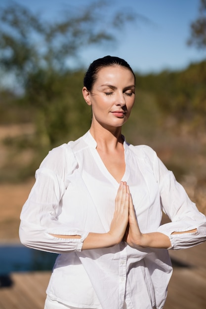 Woman performing yoga at safari vacation