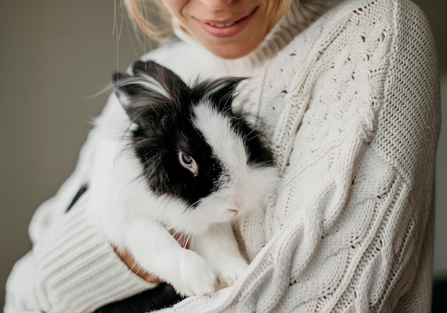 Woman petting adorable rabbit