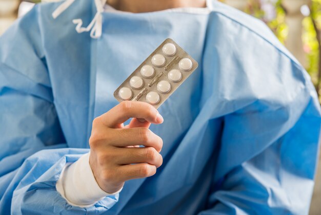 Woman pharmacist holding prescription medicine from doctor order