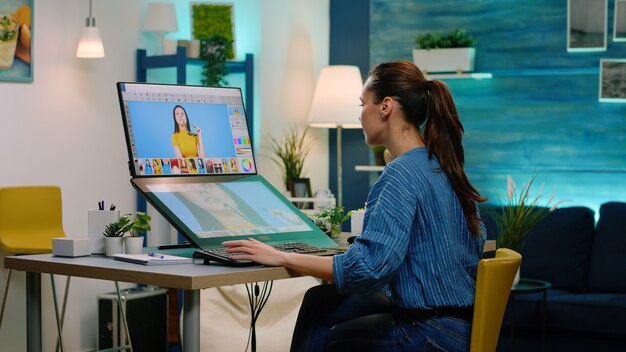 Woman photographer using touch screen computer