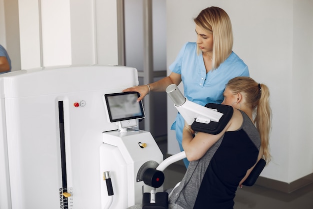 Woman at physiotherapy making physical exercises with qualified therapist