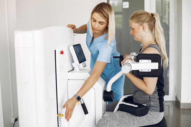 Woman at physiotherapy making physical exercises with qualified therapist