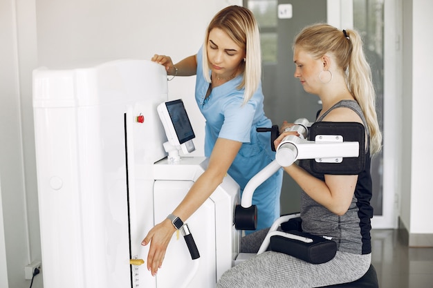 Woman at physiotherapy making physical exercises with qualified therapist