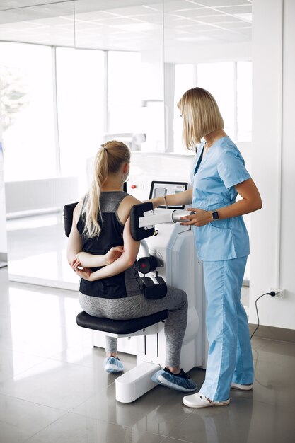 Woman at physiotherapy making physical exercises with qualified therapist