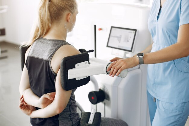 Woman at physiotherapy making physical exercises with qualified therapist