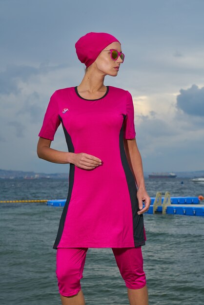 Woman in pink dress and pink headscarf