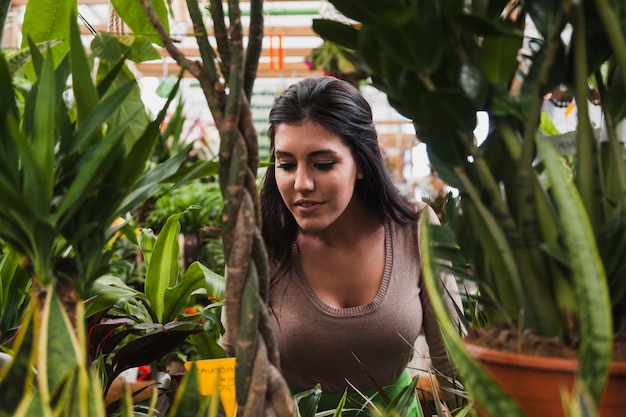 Woman behind plants