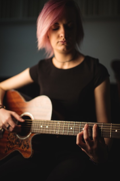 Woman playing a guitar