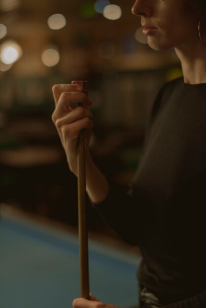 Woman playing pool at a bar