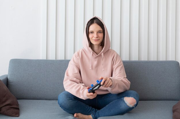 Woman playing a videogame at home