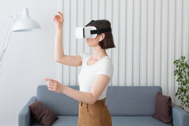 Woman playing a videogame while using vr goggles