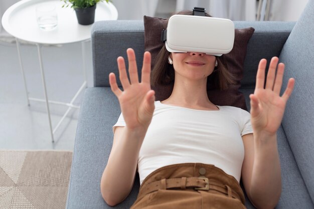 Woman playing a videogame while using vr goggles