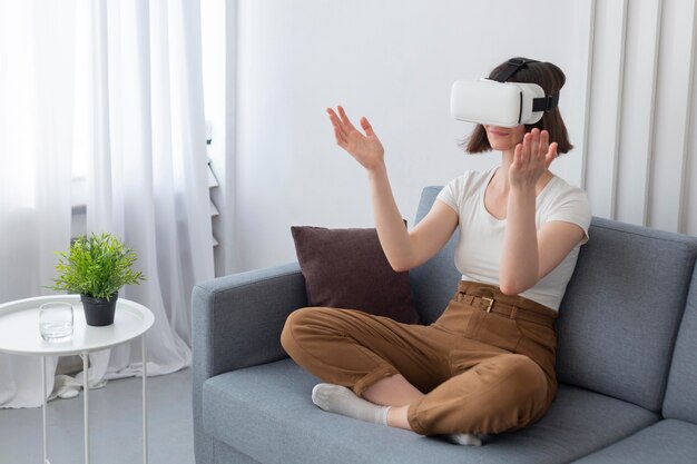 Woman playing a videogame while using vr goggles