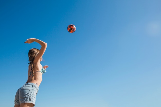 Woman playing volleyball view from below