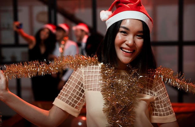 Woman playing with a garland at new year's eve party