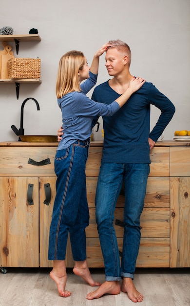 Woman playing with her husband's hair