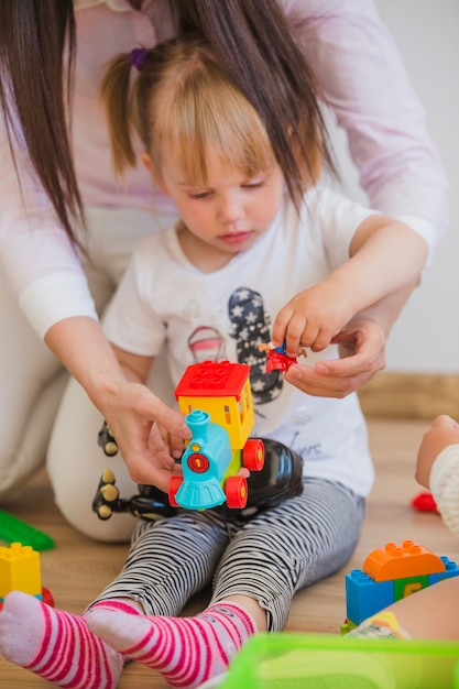 Woman playing with little girl