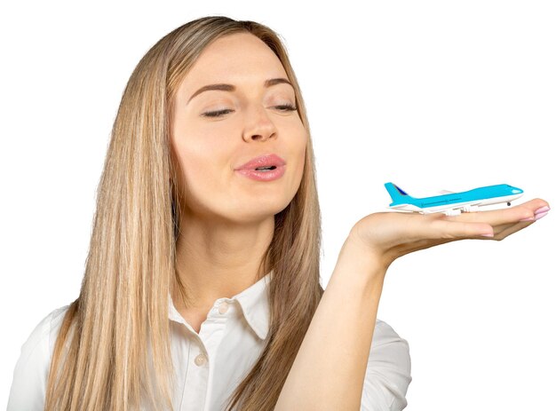 Woman playing with toy plane isolated on white