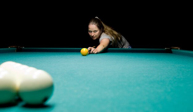 woman plays russian billiards