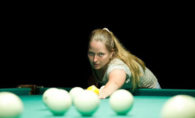 woman plays russian billiards