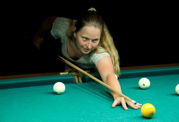 woman plays russian billiards