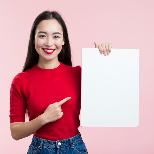 Woman pointing at blank paper sheet