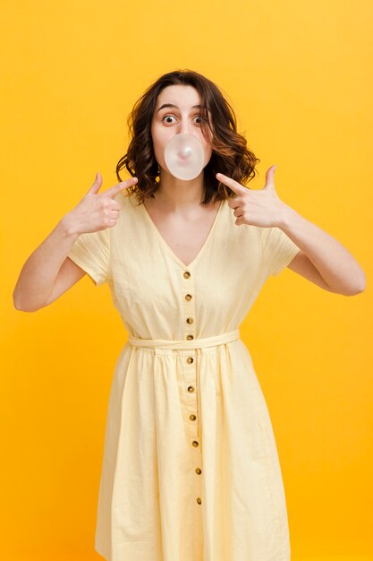 Free photo woman pointing at bubble gum