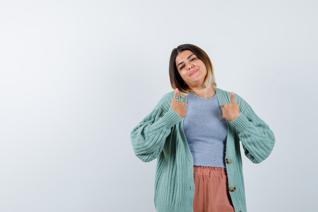 Woman pointing at herself in casual clothes and looking proud. front view.