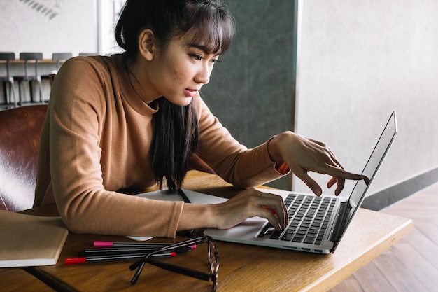 Woman pointing at laptop screen