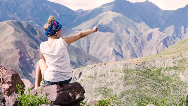 Woman pointing at the mountains