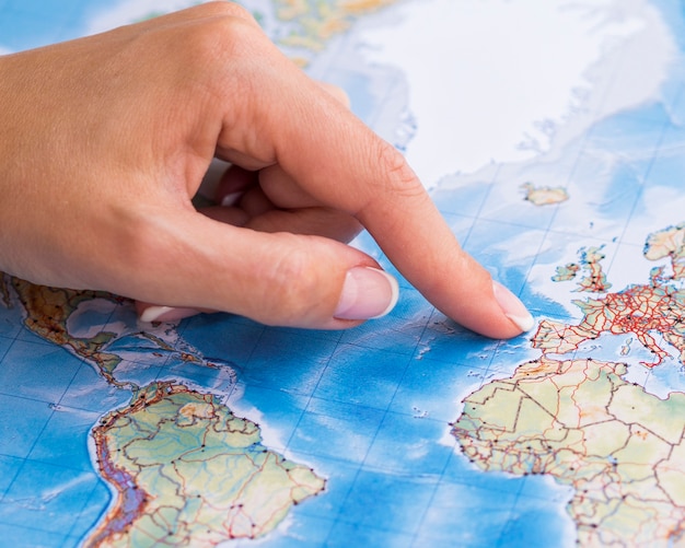 woman pointing at portugal on the map