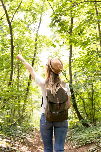 Woman pointing at the sky from behind