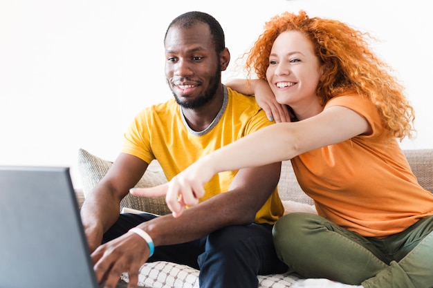 Woman pointing something on a laptop