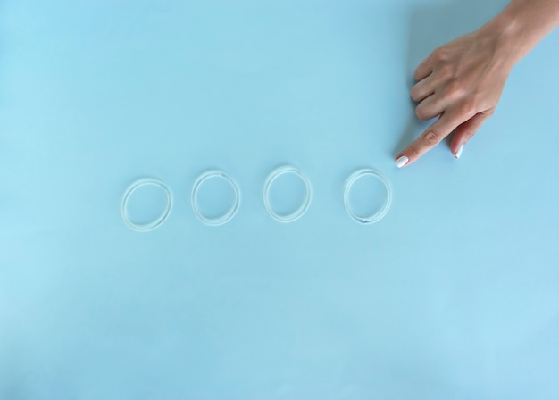 A woman points to the vaginal ring for contraception purposes