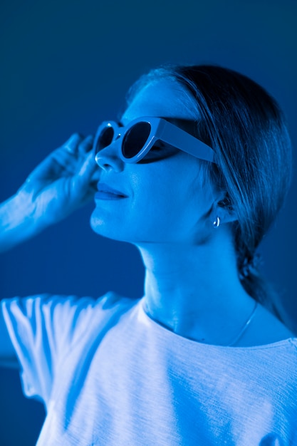 Free photo woman portrait with blue lights visual effects