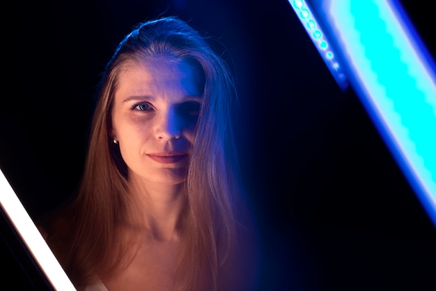 Free photo woman portrait with blue lights visual effects