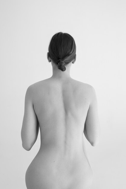 Woman posing black and white nudity back view