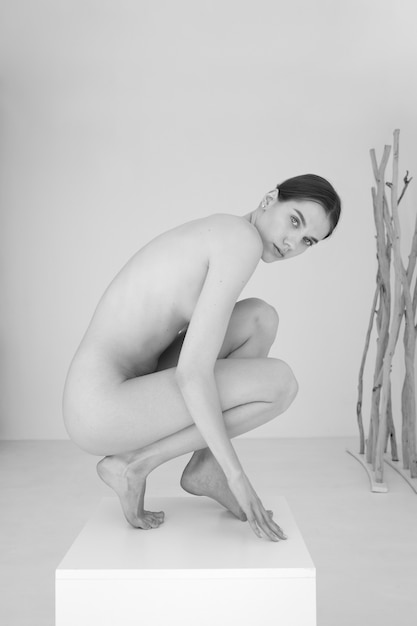 Woman posing black and white nudity side view