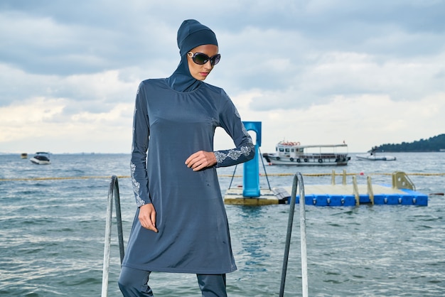 Free photo woman posing in a blue dress and headscarf