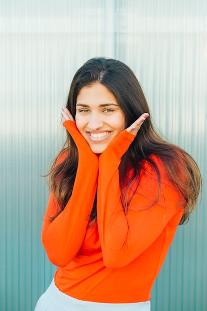 Woman posing in front of metallic backdrop