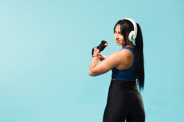 Woman posing in gym outfit and headphones