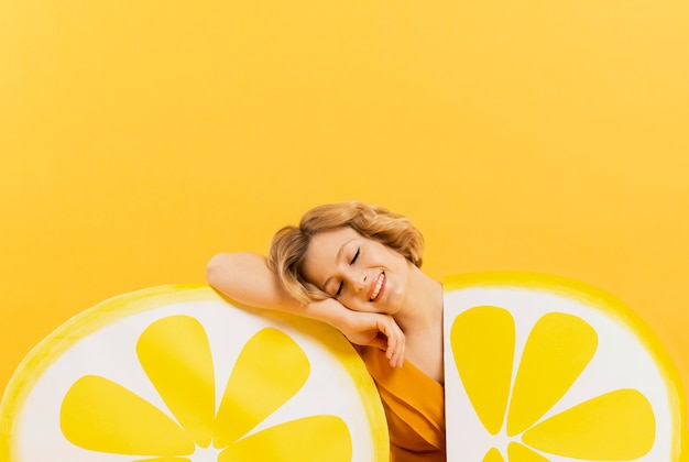 Woman posing happily with lemon slices decorations