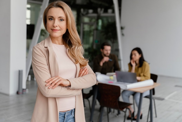 Woman posing next to her coworkers