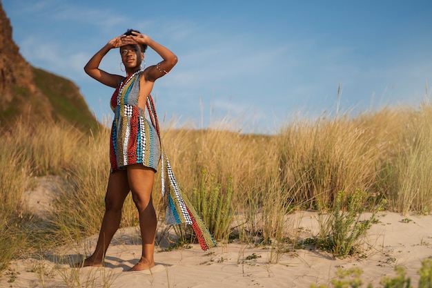 無料写真 乾燥した環境でアフリカ原産の衣服を着てポーズをとる女性
