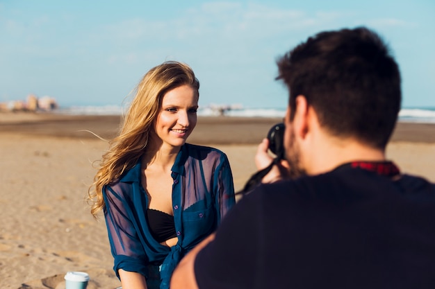 Woman posing for man on beach