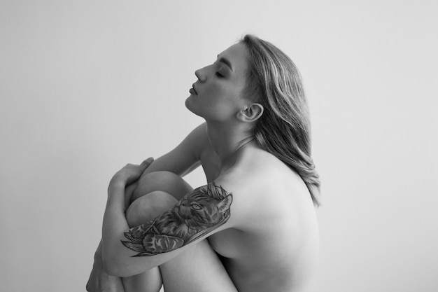 Woman posing nude side view