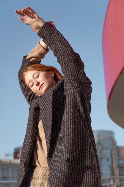 Woman posing outside against the sky