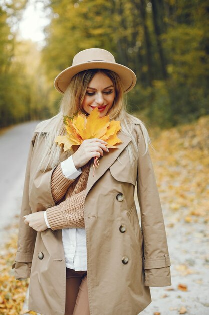 Woman posing for a photo in the autumn park