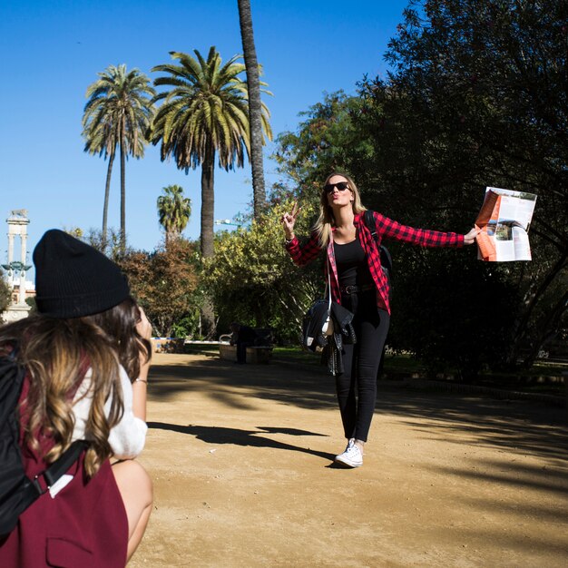 Woman posing for photo her friend taking